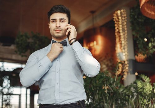 stylish-businessman-blue-shirt-standing-indoor_1157-33227