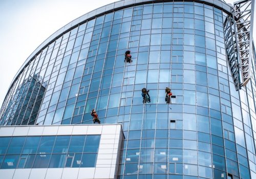 workers-washing-windows-office-building_1153-4659